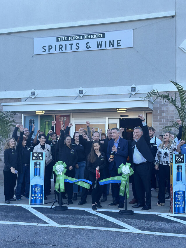 The Fresh Market Spirits &amp; Wine staff gather celebrate the grand opening