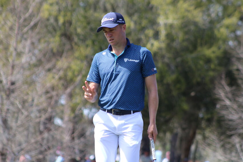 Justin Thomas waves to the crowd after a birdie on No. 7 en route to his tournament record-tying 62 during the second round of THE PLAYERS.