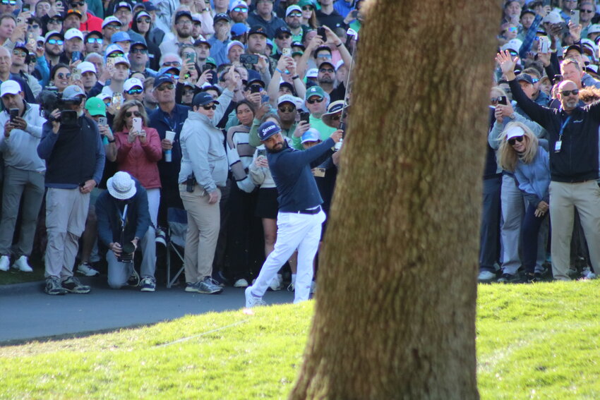 J.J. Spaun hits his second shot from the near the cart path on No. 18.