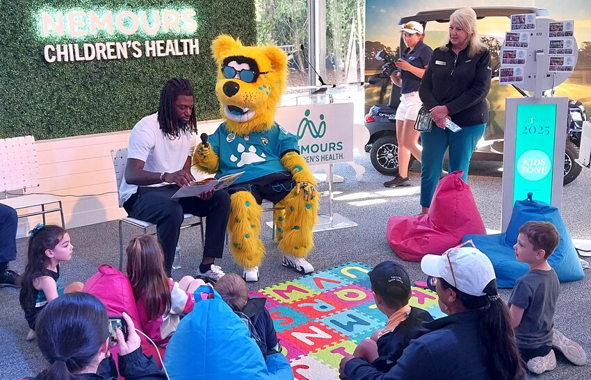 Jacksonville Jaguars wide receiver Brian Thomas Jr. reads Jaxon de Ville’s “Jaxson’s Big Jump” to children Thursday, March 13, at the Kids Zone.