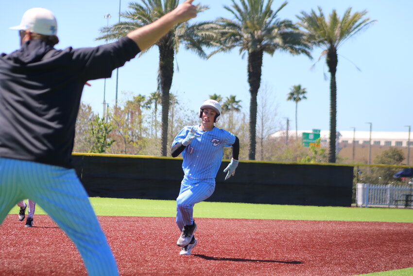 Maddox Tepper is in a full sprint rounding third to score a run for the Sharks against Fletcher at Fort Family Regional Park in Jacksonville.