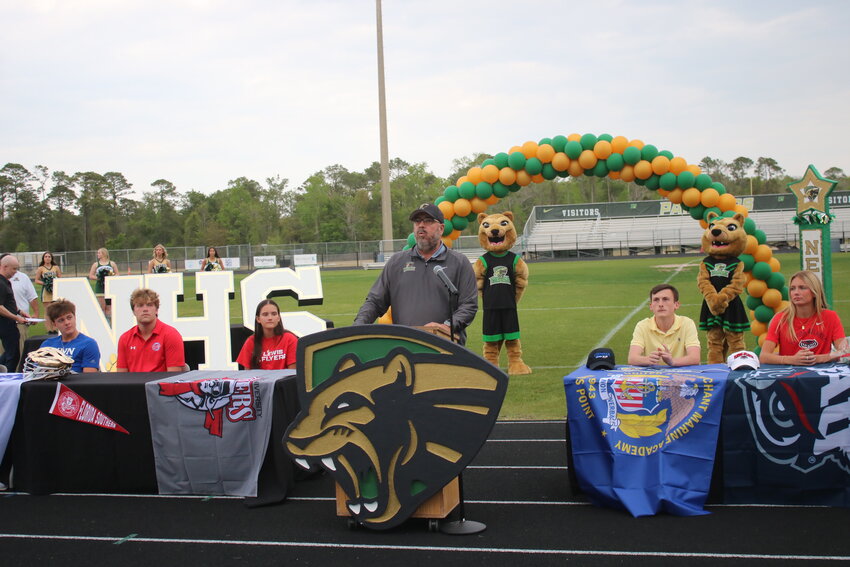 Nease athletic director Christos Mastoridis speaks during the signing ceremony on Monday, March 24.