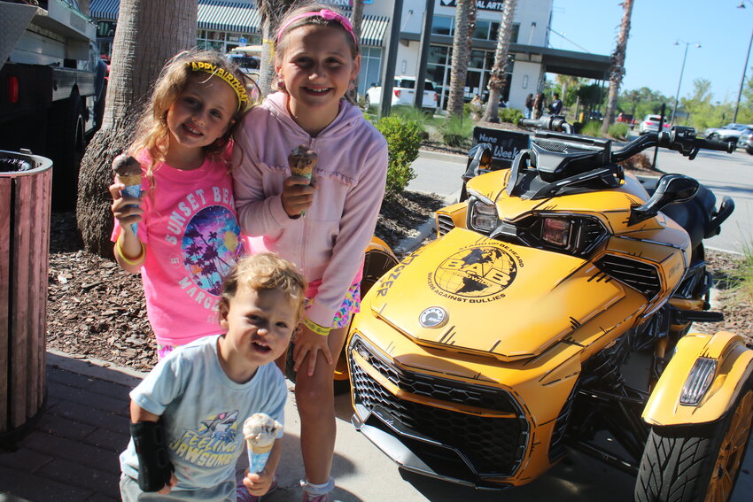 Children enjoy ice cream next to the &ldquo;Bullydozer&rdquo; during Free Cone Day at Ben &amp; Jerry&rsquo;s in Nocatee on April 8.