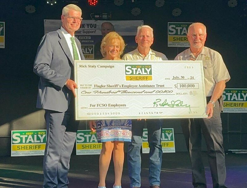 Staly presents the check.