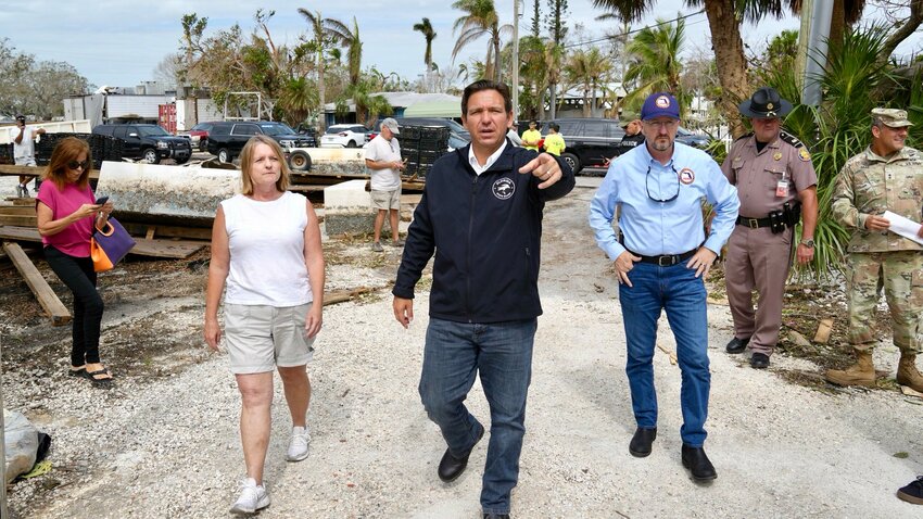 Gov. Ron DeSantis with law enforcement personnel in a Milton-damaged region in Florida.