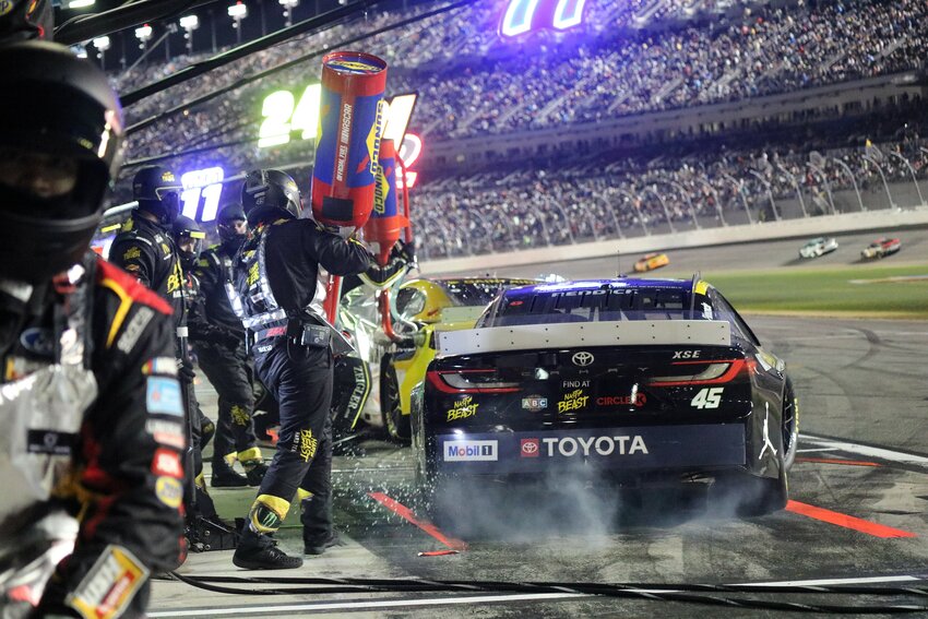 Tyler Reddick’s #45 crew performs a pit stop under the lights. | Eryn Harris