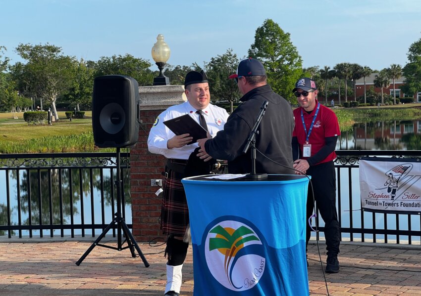 Lt. Patrick Juliano is honored by Chief Kyle Berryhill and Patrick Appolonia.