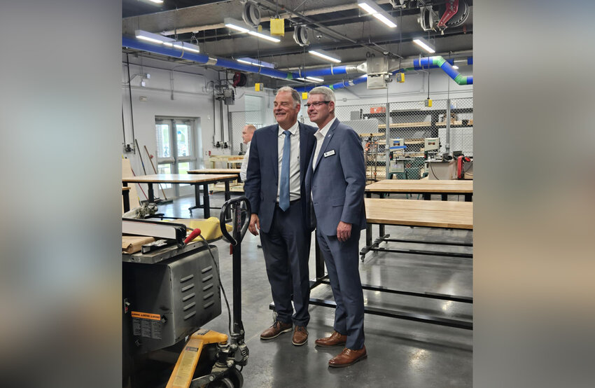 Flalger Schools Teaching and Learning Director Jeff Reaves and School Board member Derek Barrs take in the new construction workshop.