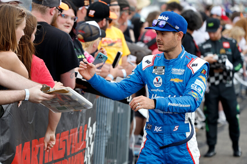 MARTINSVILLE, VIRGINIA - APRIL 16: Kyle Larson, driver of the #5 HendrickCars.com Chevrolet, signs autographs for NASCAR fans on the red carpet prior to the NASCAR Cup Series NOCO 400 at Martinsville Speedway on April 16, 2023 in Martinsville, Virginia. (Photo by Sean Gardner/Getty Images)