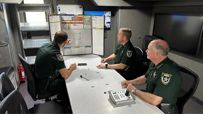 Sheriff Rick Staly (right) helping monitor the situation from a mobile command unit.