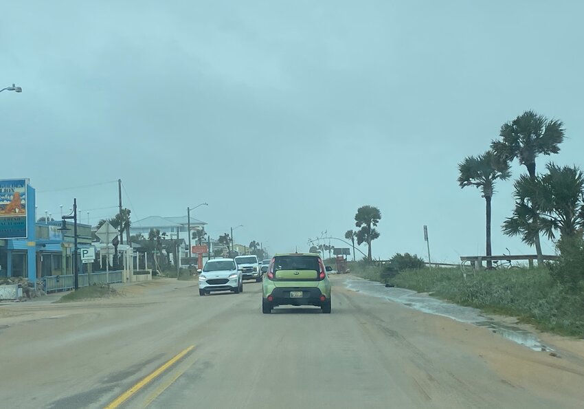 Vehicles driving on the still-sandy SR-A1A Thursday morning.