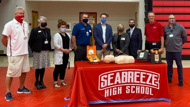 Pictured from left are Brad Montgomery, Seabreeze Athletic Director; Kelly Amy, Manager, Strategic Partners; Kelley Lemon, Seabreeze Athletic Trainer; Erik Nason, AdventHealth Coordinator, Sports Medicine Outreach; Jeff Perlow, ZOLL Medicine, Manager; Rachelle Shipp, School Health, Manager; Carl Persis, School Board Member; Joe Rawlings, Seabreeze Principal; and Lary Beal, Specialist, Athletics.