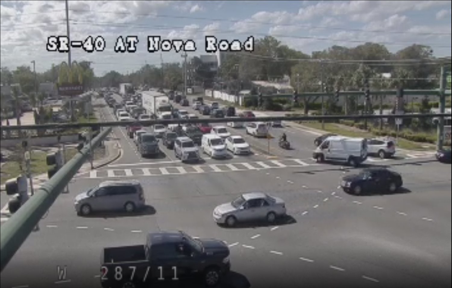 Traffic on Granada Blvd at Nova Road in Ormond. Traffic can be seen building on both sides of the roadway.