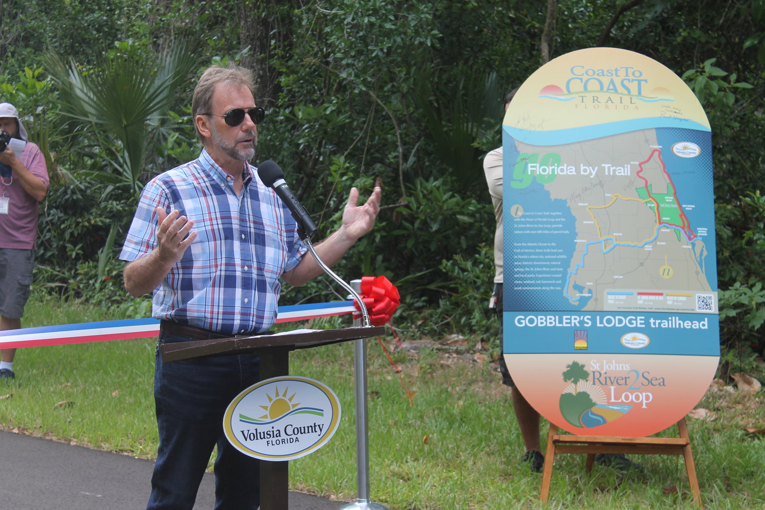 County Chair Jeff Brower speaking to the public a ribbon-cutting event in May 2022.