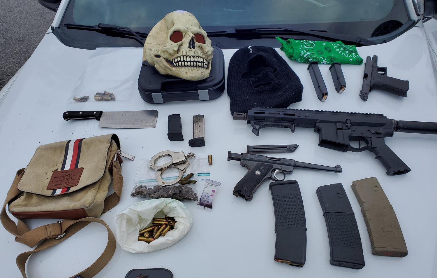 The masks, ammunition, guns, and drugs discovered by deputies