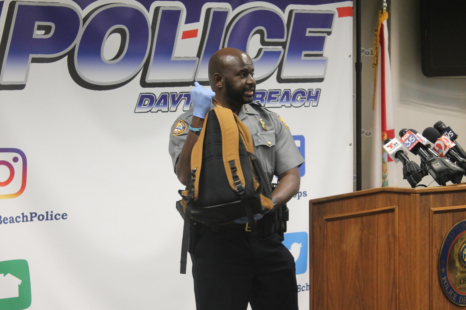Chief Jakari Young holding Hagins' backpack, which contained a rifle, boxes of ammunition, loaded magazines, a scope, and hearing protection