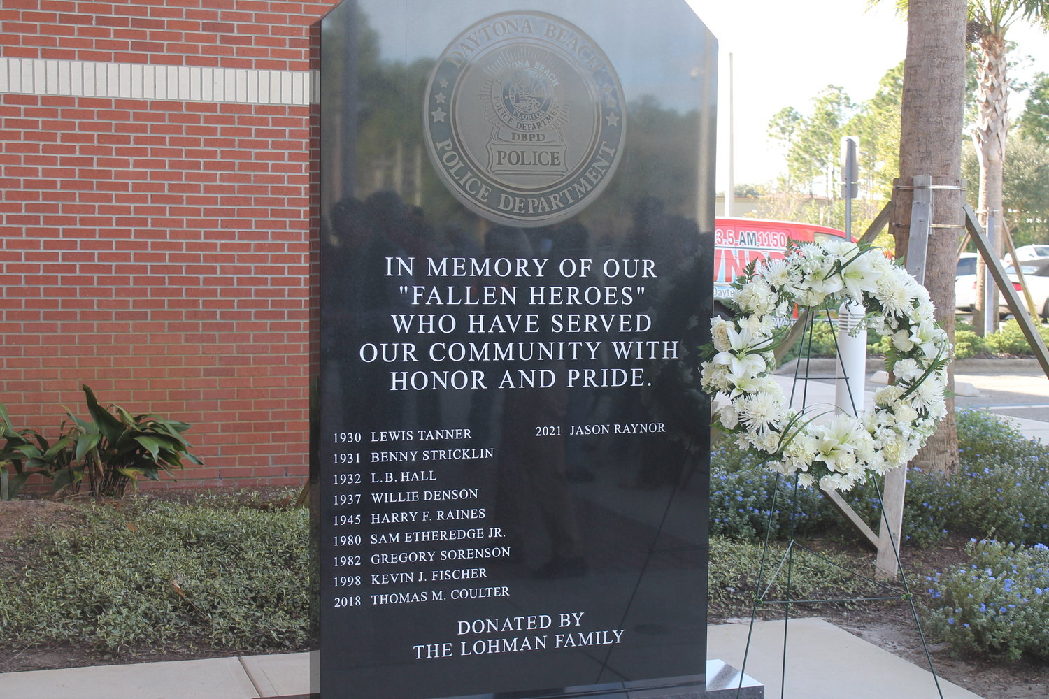 The new memorial in front of the DBPD headquarters, now featuring Officer Jason Raynor's name