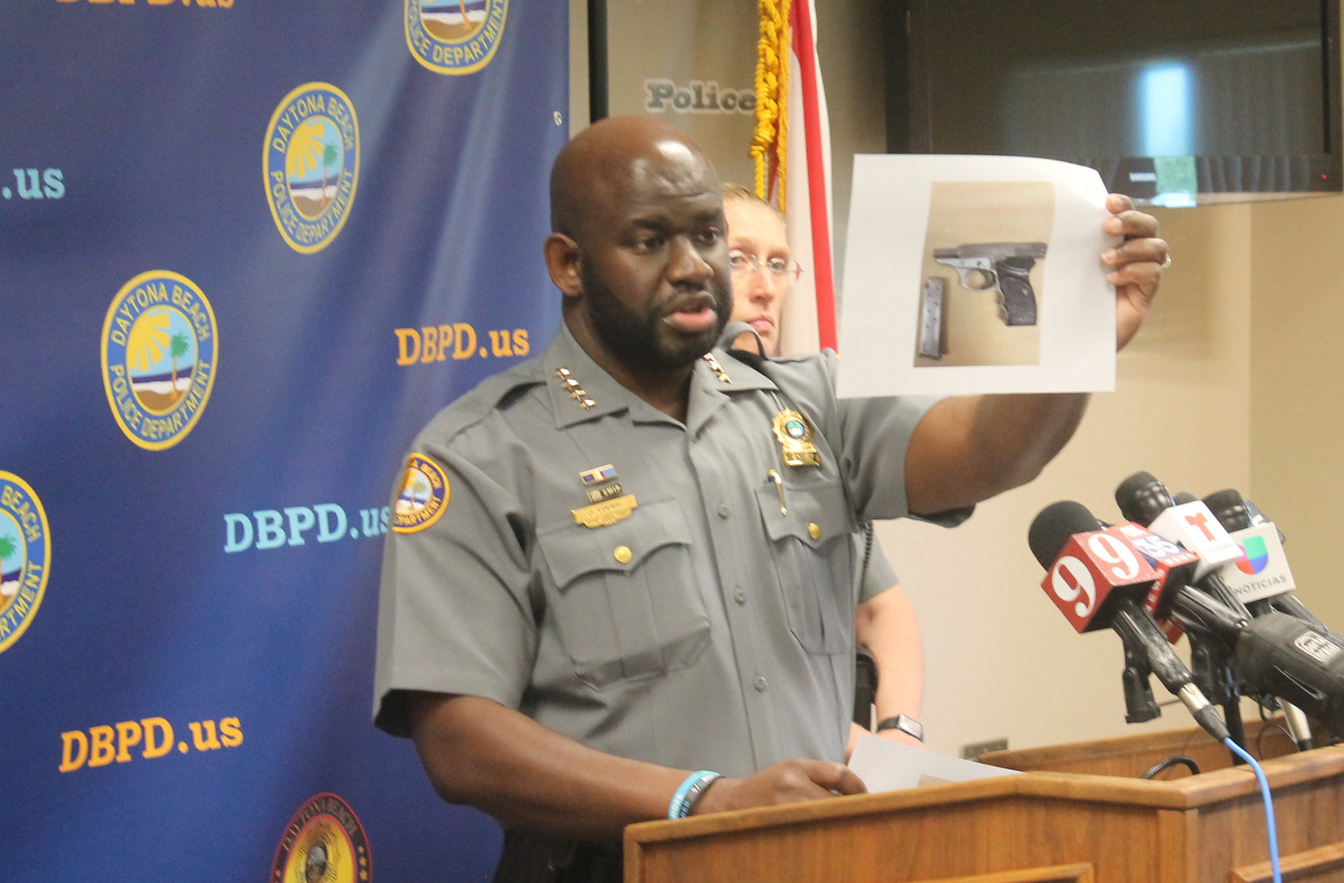 Chief Jakari Young showcasing the loaded gun Lansing had in the vehicle at the time of the shooting