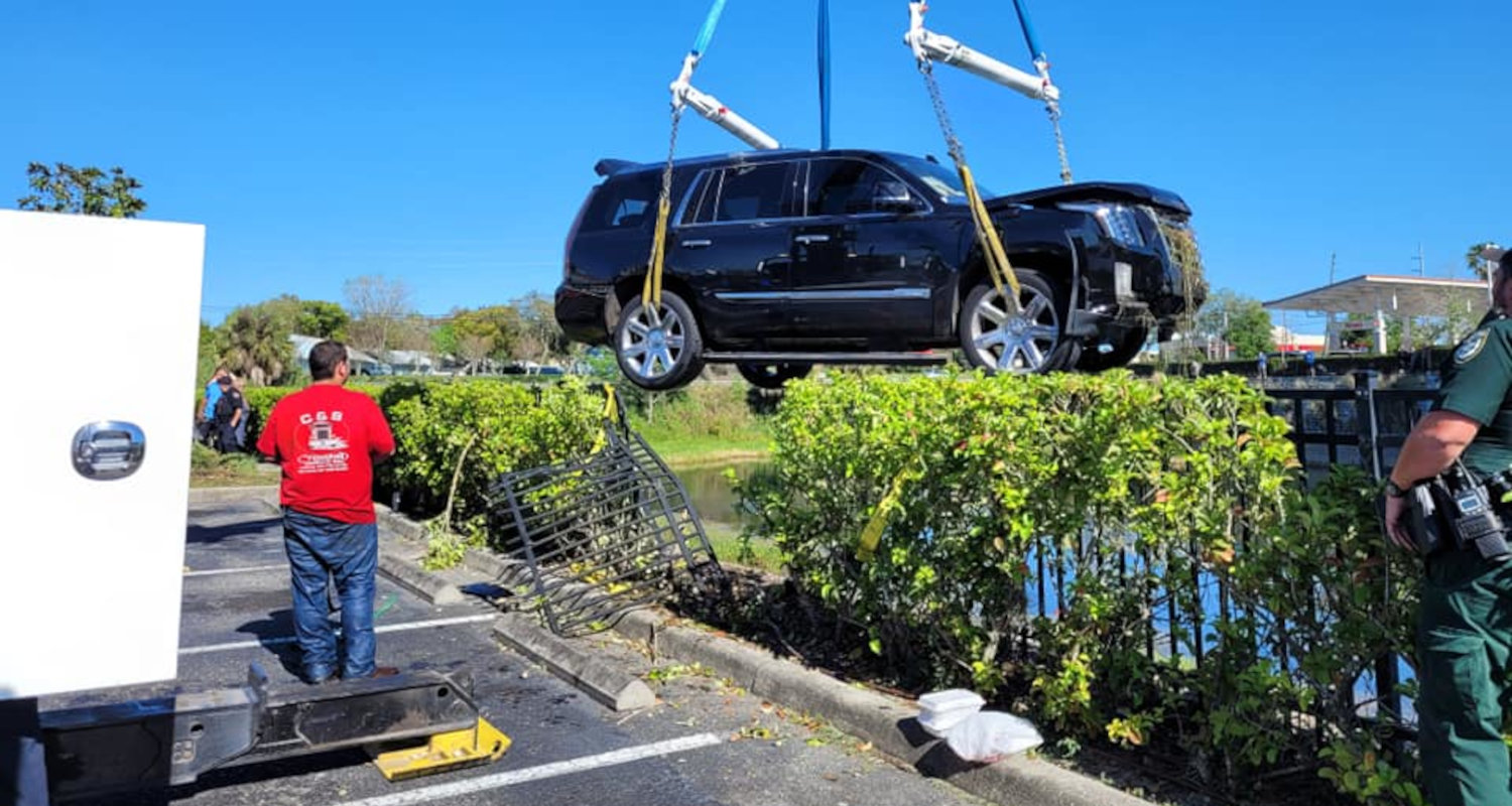 PHOTOS: Occupants Rescued After SUV Plunges Into Pond