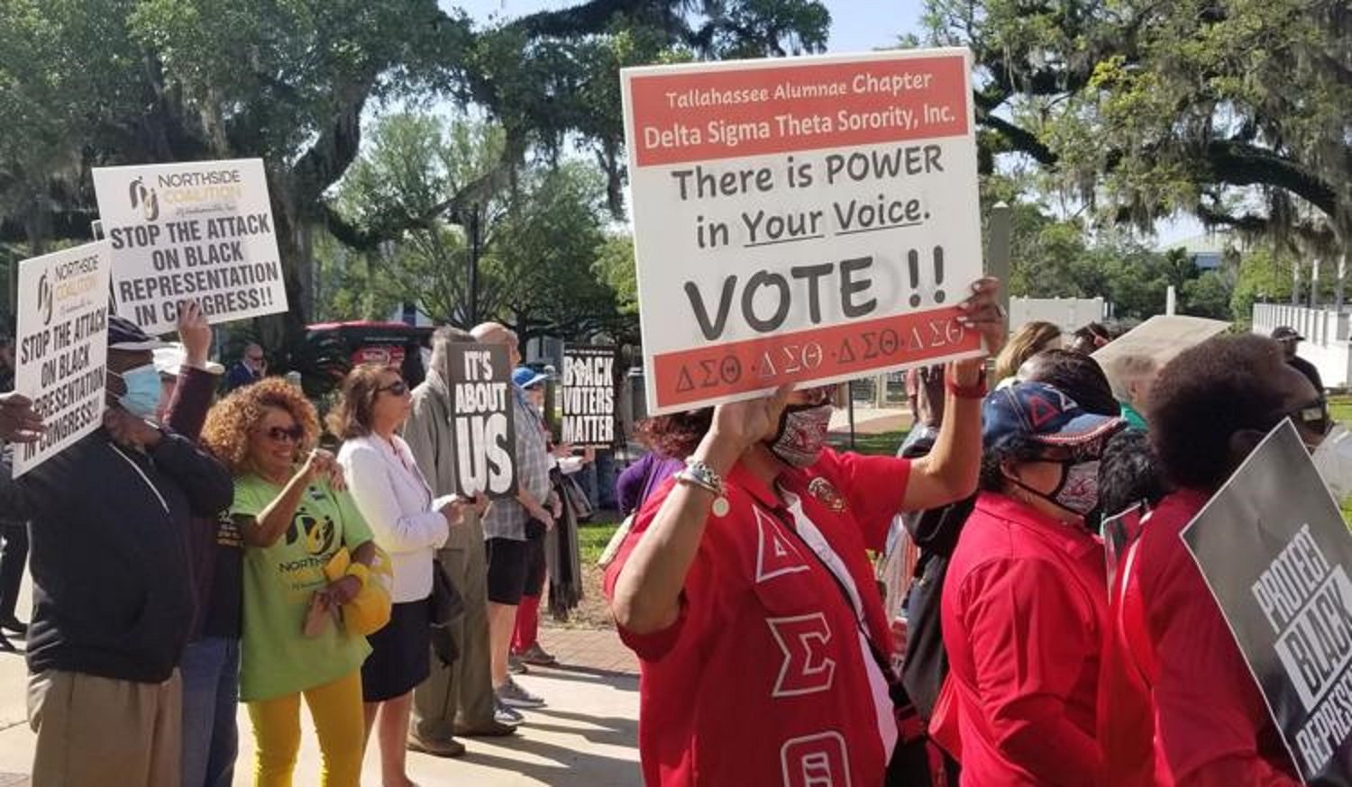 Opponents of a congressional redistricting proposal protest Tuesday outside the state Capitol