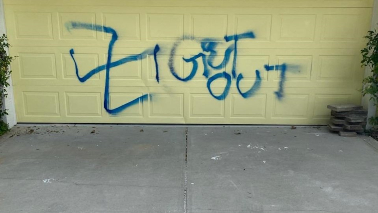 The graffiti left on the garage door of a John Anderson Drive home