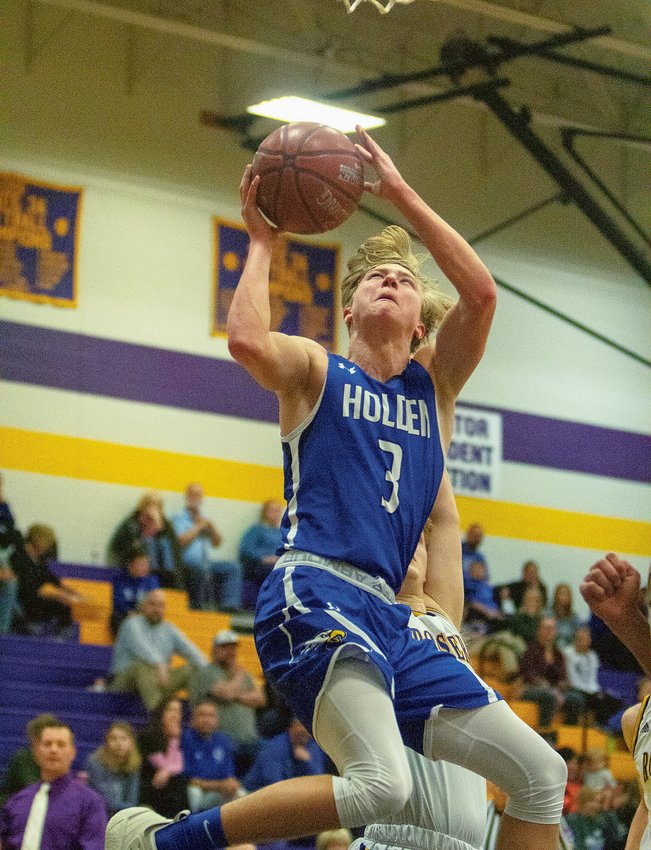 Holden senior Jayden Brown skies for a layup in the first half of the Eagles 78-41 loss to Pleasant Hill on Jan. 8. Brown became the most recent Holden athlete to score 1,000 points in their career, reaching the milestone with 16 points against the Roosters.