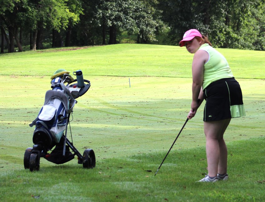 Hannah Taylor lines up her shot at Hidden Pines Golf Course during the first week of practice for Warrensburg High School girl&rsquo;s golf team.