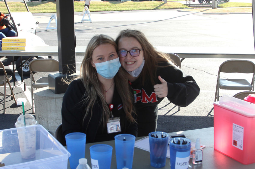 Nursing students Riley Greenwell and Ariel Howrey man one of the tents for a drive-thru flu shot clinic Thursday, Nov. 5, on the University of Central Missouri campus.&nbsp;&nbsp;