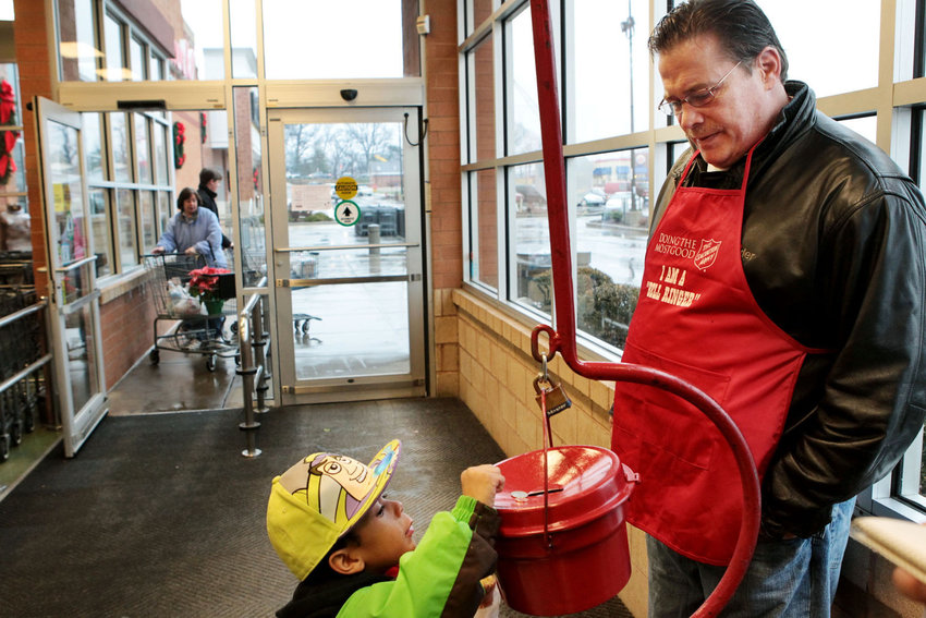 Volunteer Salvation Army bell ringer Christopher Simonds, part of Painters' District Council No. 2 for painters and glaziers, greets 5-year-old Elijah Thompson as he donates extra change on Saturday morning, Dec. 11, 2010, at the Schnucks grocery store on Loughborough Avenue in south St. Louis City. Erik M. Lunsford elunsford@post-dispatch.com