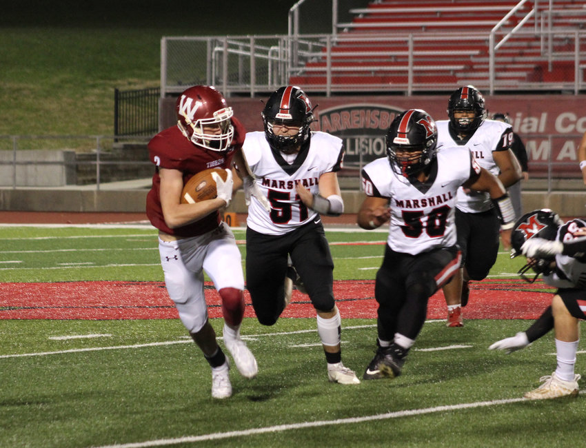 Zach Munsterman makes his way past Marshall defenders during Warrensburg&rsquo;s first district match-up Friday, Oct. 30.