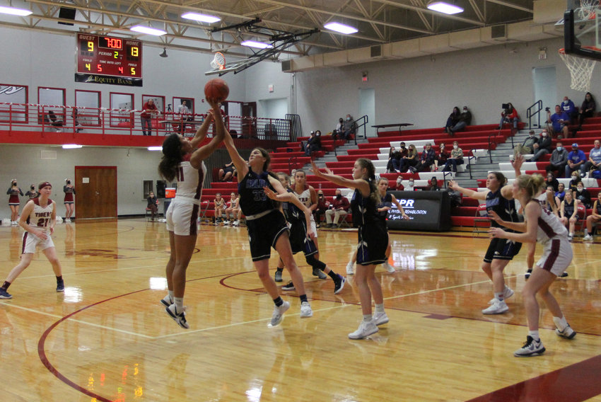 Kimberly Maxwell tries to get a shot past Camille Davidson during Warrensburg&rsquo;s game against Holden Friday, Dec. 11.