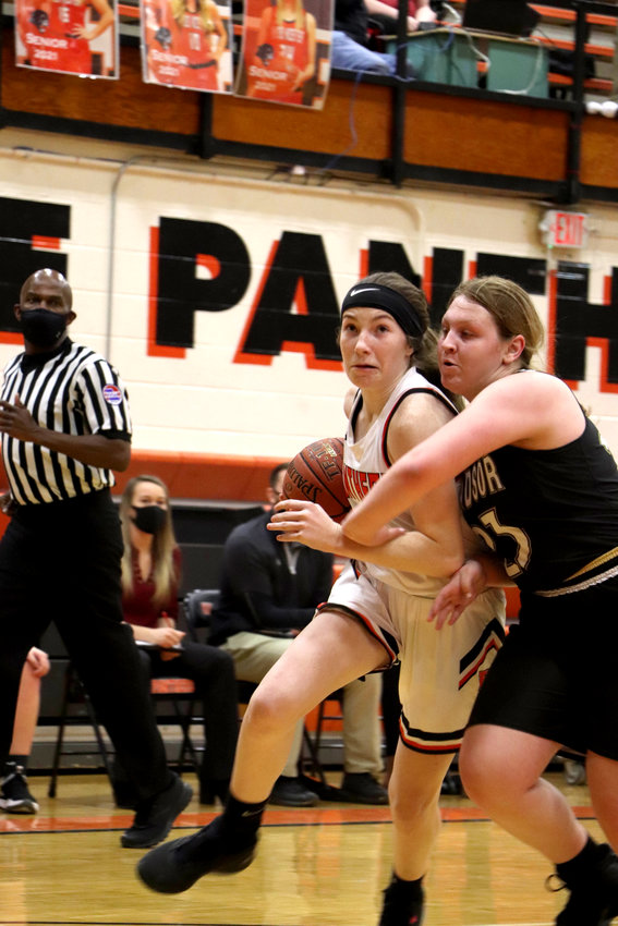 Knob Noster's Caylie Holyfield tries to drive past a Windsor defender on Monday, Dec. 14.