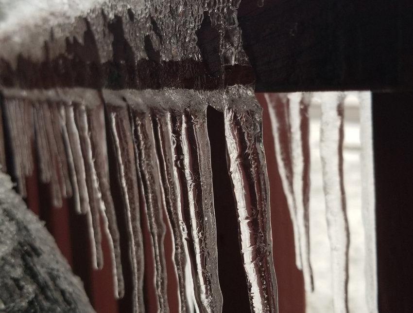 Icicles descend from an ice-covered railing after a winter storm of ice, sleet and snow Thursday, Dec. 31, into New Year&rsquo;s Day, Jan. 1, in Warrensburg.