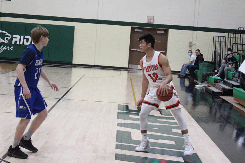 Knob Noster sophomore Anthony Lopez looks to navigate Holden senior Adam Comer during the Quarry City Cougar Classic third place game on Saturday, Jan. 30 at the Crest Ridge Secondary School.
