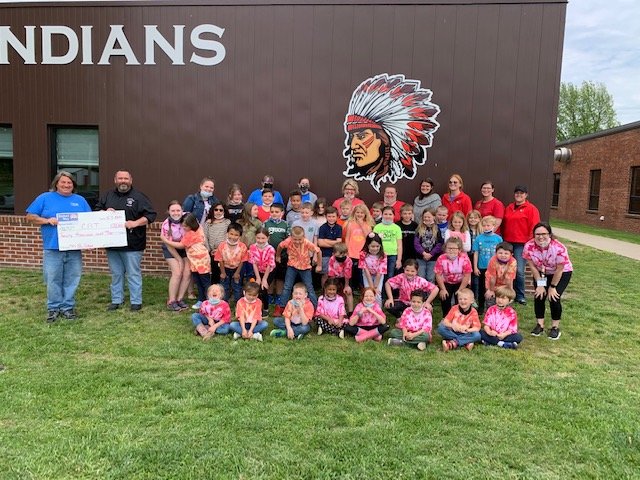 Johnson County United Way Executive Director Scott Holmberg presents a donation to Chilhowee School District Superintendent Joe Murphy alongside Chilhowee School District staff and students on Friday, May 7, to help fund the district&rsquo;s new preschool.