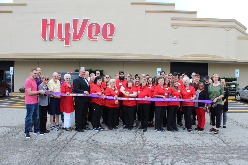 Hy-Vee employees cut the ceremonial ribbon alongside community members and Warrensburg Chamber of Commerce members and staff to celebrate the store's grand opening on Tuesday, May 18.