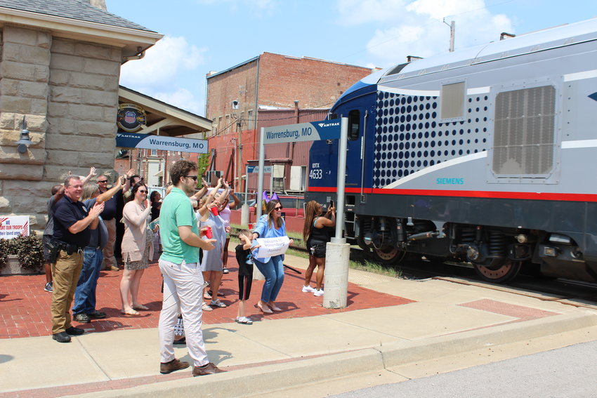 Community members welcome the Amtrak Missouri River Runner as it arrives at the Warrensburg train depot at about noon on Monday, July 19, 2021.
