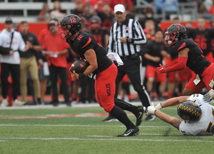 Central Missouri quarterback Logan Twehouse escapes several tackles before reaching the end zone for a touchdown that tied the game in the second half Saturday.