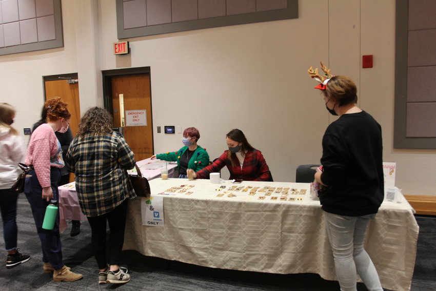 Lauren West, senior middle school education major, and Vickii Swanson, junior communication major, sell earrings Wednesday, Dec. 1, at the 13th annual University of Central Missouri Holiday Market.