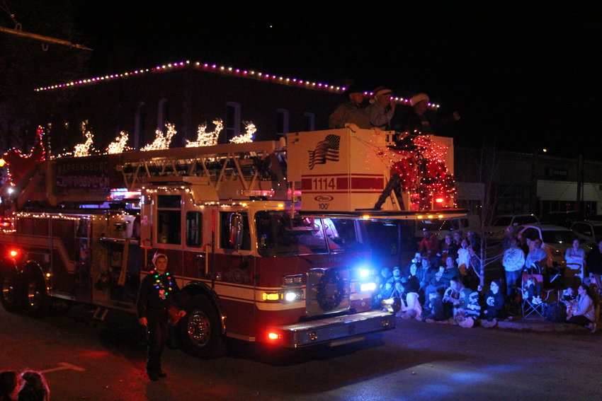 The Warrensburg Fire Department ladder truck, fully decked out with Santa&rsquo;s sleigh and reindeer, makes its way through downtown for the Holiday Parade on Friday, Dec. 3, in Warrensburg.