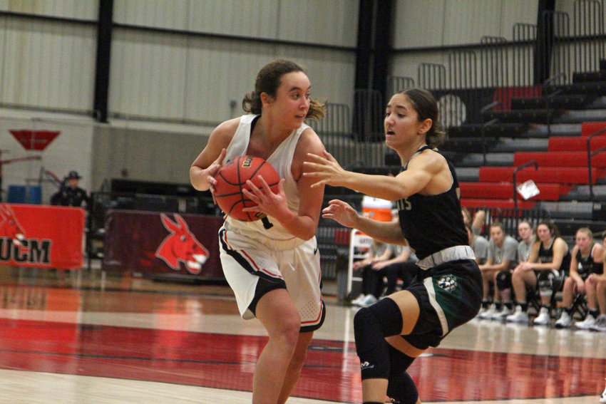Central Missouri redshirt freshman Olivia Nelson drives into the paint as she faces pressure from freshman Evelyn Vazquez on Monday, Dec. 13, at the UCM Multipurpose Building.