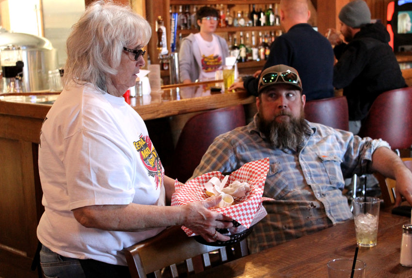 Karen Darling talks to a customer during the lunch shift Wednesday at Pub 13, 5 state Route V in Warrensburg. The restaurant and bar opened in August next to the Central Missouri Speedway.