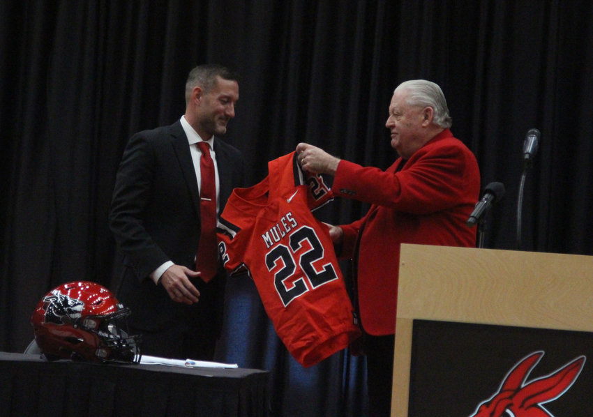 University of Central Missouri Vice President of Intercollegiate Athletics Jerry Hughes presents Josh Lamberson with a Mules football uniform on Wednesday, Feb. 9, at the Multipurpose Building.