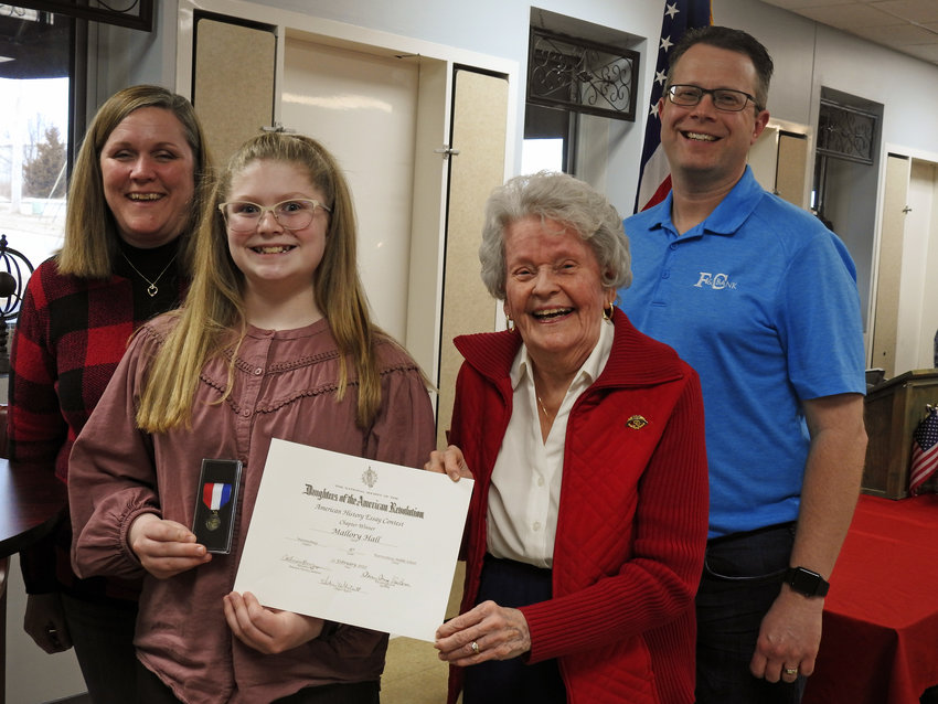Warrensburg student Mallory Hill is recognized as the American History Essay winner. From left, Kim Hill, Mallory Hill, American History Chair Virginia Campbell and Greg Hill.