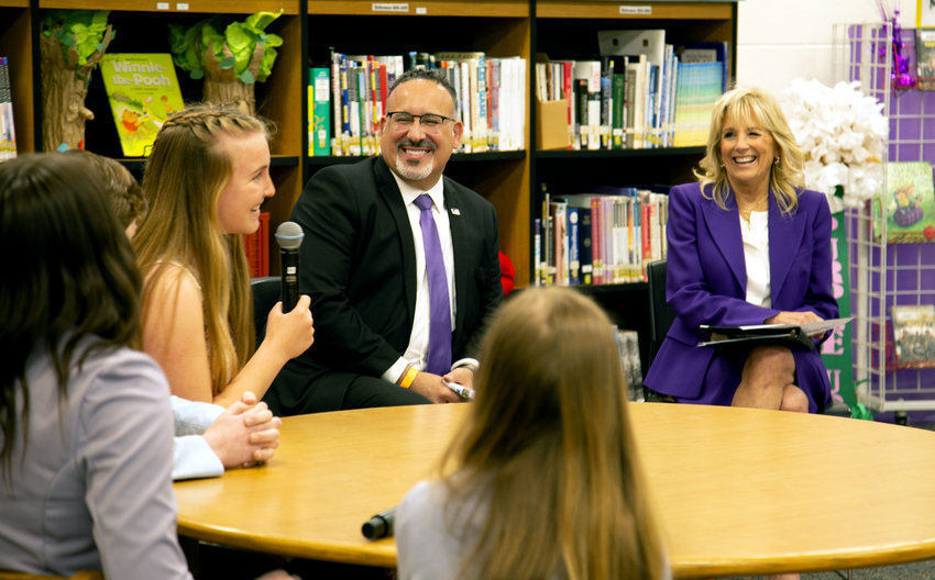 Jane Yates, a Knob Noster High School senior, laughs with U.S. Secretary of Education Miguel Cardona and First Lady Jill Biden during a roundtable discussion on Wednesday afternoon at Whiteman Elementary. Biden and Cardona visited the Knob Noster School District as part of Month of the Military Child.