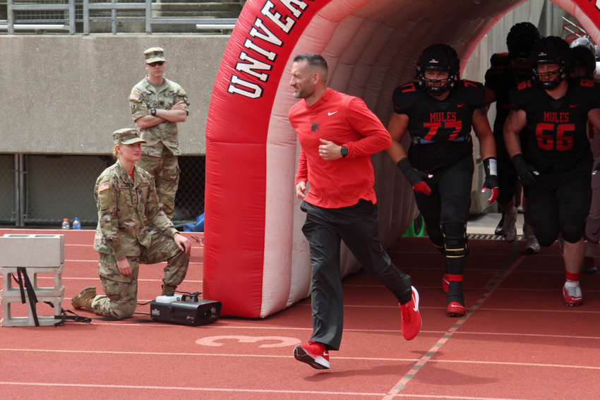 Mules football head coach Josh Lamberson runs out of the tunnel prior to UCM&rsquo;s spring game on Saturday, April 23, at Walton Stadium.