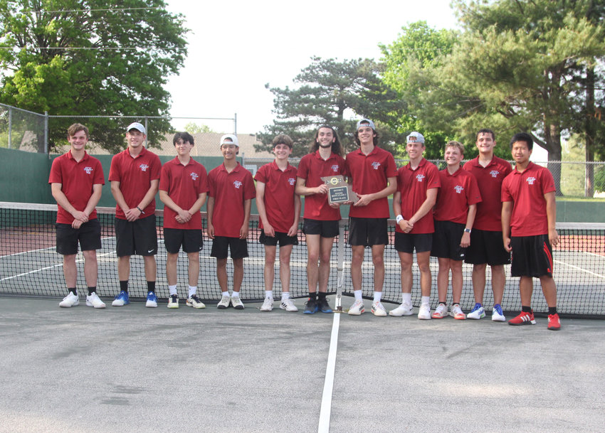 Warrensburg boys tennis poses for a team photo with its Class 1 District 13 championship plaque on Wednesday, May 11, at Grover Park.