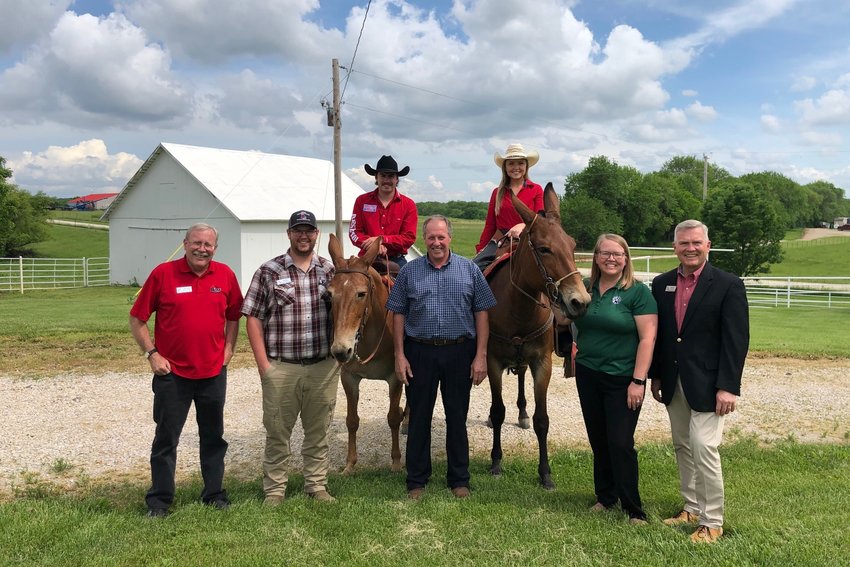 everal individuals from the University of Central Missouri, including participants in the MO-FEN event, gather for a photo during a tour of the university&rsquo;s farms. From left, Mark Goodwin, UCM professor of horticulture; Travis Hume, director of UCM Farms; Nathan Frazee, apprentice mule mascot rider sitting on &quot;Mancow&quot; (Tammy); Chris Boeckmann, farm superintendent at Lincoln University; Victoria Happy, mule team trainer sitting on Molly; Jill Brown, director of corporate relations at Northwest Missouri State University; and David Pearce, UCM executive director of Government Relations.