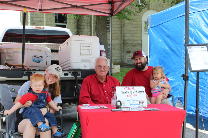 The Turnbow family poses for a photo at their booth at the Warrensburg Farmers&rsquo; Market outside the Johnson County Courthouse. The legacy vendor booth, Turnbow Livestock, can be found at the farmers market every Saturday this summer from 8 a.m. to noon.