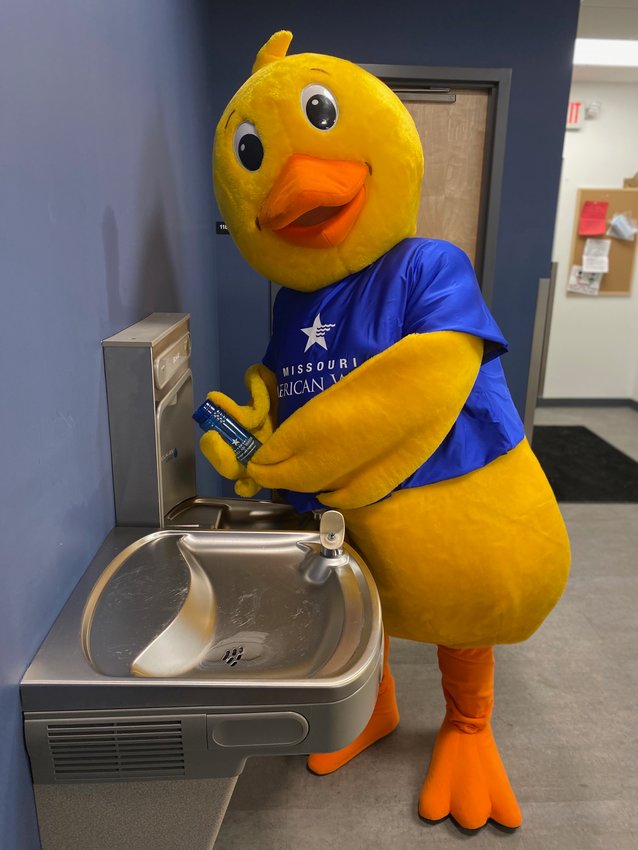 Missouri American Water mascot Puddles shows off an example of a hydration station.